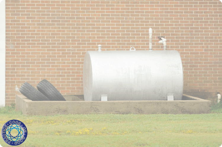 An oil tank enclosed within a built retaining wall.