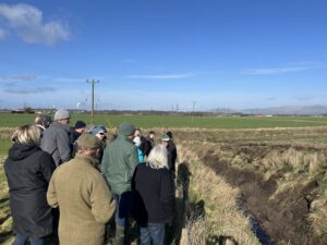 Farmers discuss with SEPA about dredging alongside a steep banked ditch.